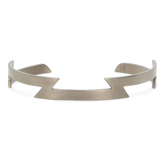 Handmade titanium bracelet with angular design and engraved 'M' by Maxwell Pontail.
