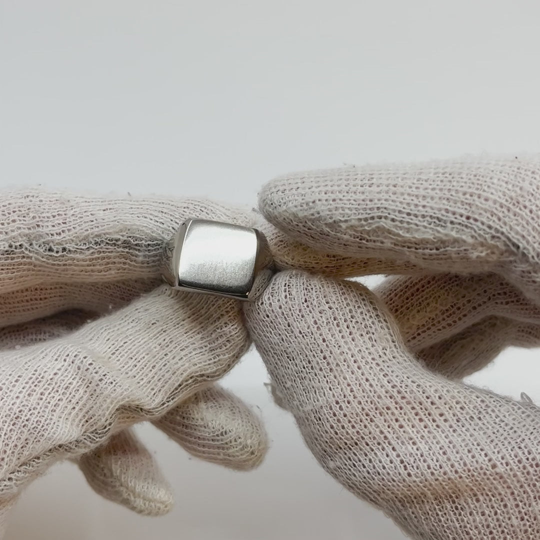 Showing all angles of a single silver-colored titanium signet ring, 15x15 mm wide surface.