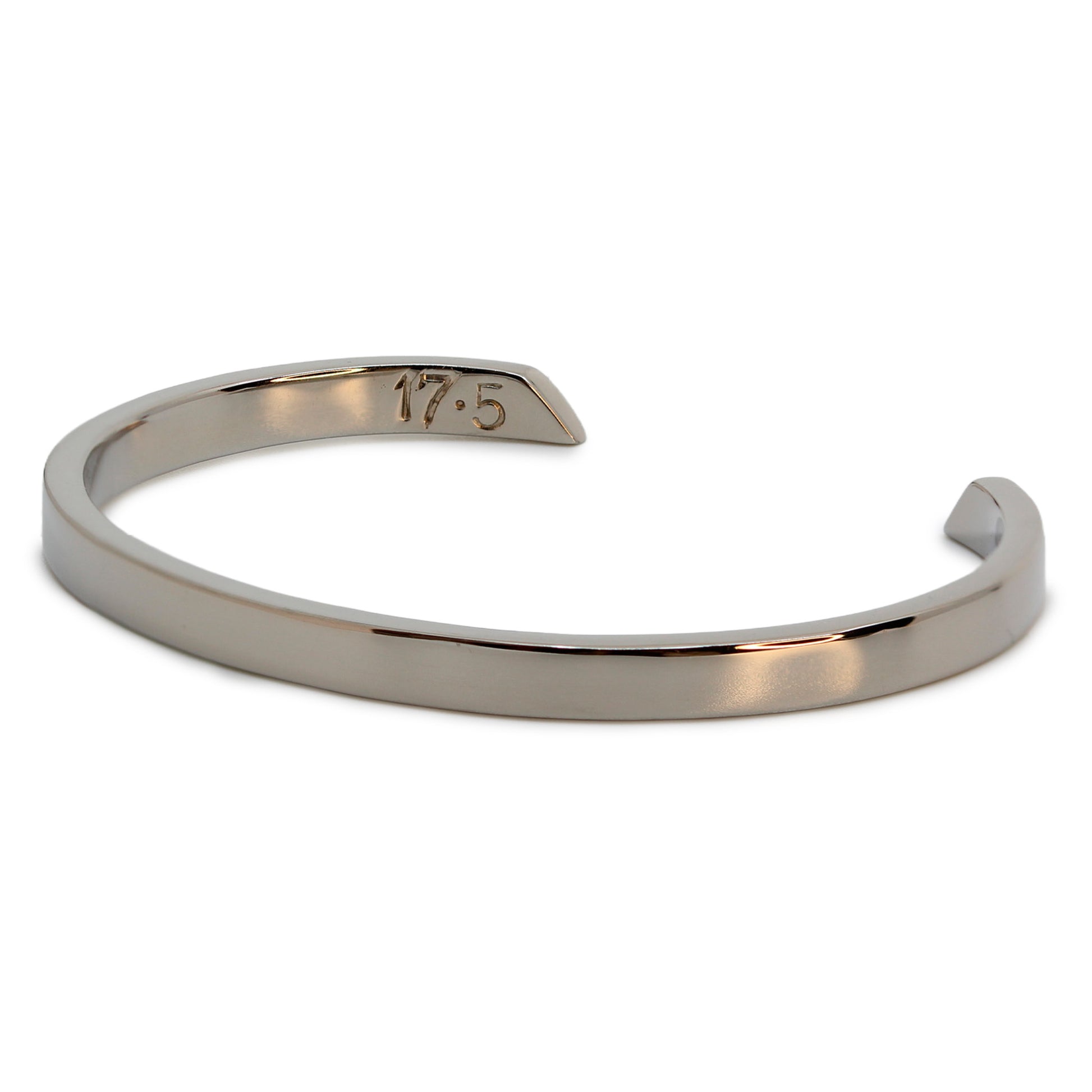 Single silver-colored titanium bangle, 5 mm wide. Image shows corner view of bangle.
