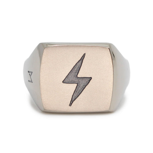 Single silver-colored titanium signet ring, 15x15 mm wide surface with an engraved lightning bolt. Image shows front view of the ring