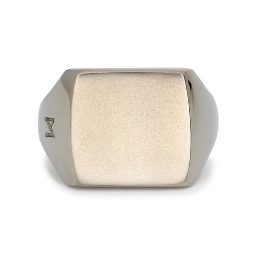Single silver-colored titanium signet ring, 15x15 mm wide surface. Image shows front view of the ring