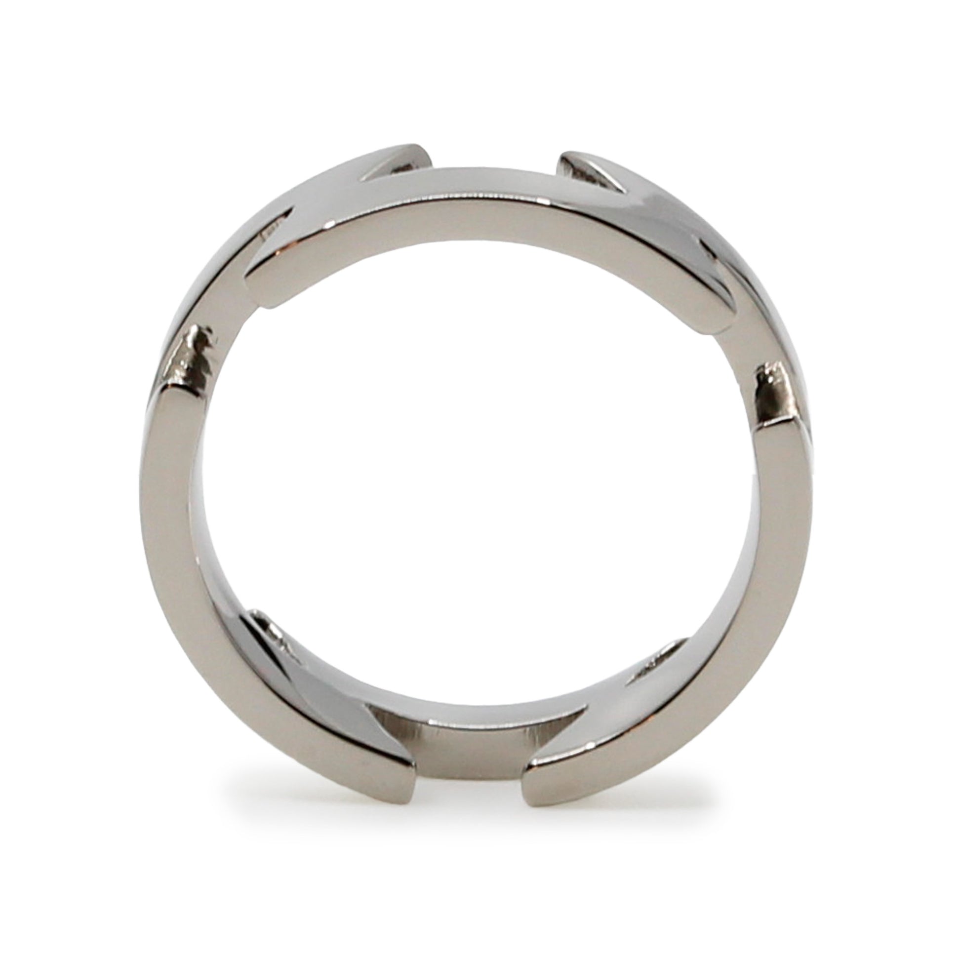 Single silver-colored titanium ring with zig-zag pattern, 6 mm thick. Image shows front view of the ring while it standing balancing on its side.